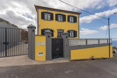 a yellow house with a black gate at FLH Papaya Villa with Sea View in Funchal