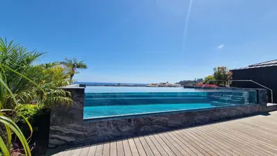 a swimming pool with blue water in a house at The Urban Retreat by LovelyStay in Funchal