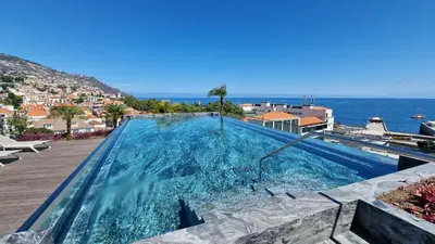 a swimming pool with a view of the ocean at The Urban Retreat by LovelyStay in Funchal