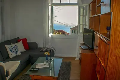 a living room with a couch and a window at Typical Farm Apartment in Arco da Calheta