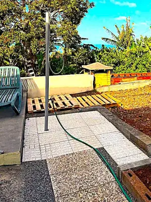a bench with a hose attached to a pole at Typical Farm Apartment in Arco da Calheta