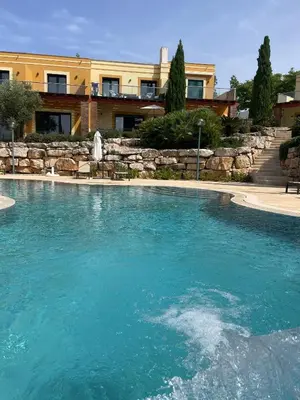 a large pool of blue water in front of a building at No14 Lote B, Quinta da Belavista in Luz