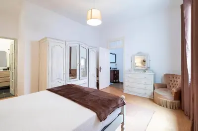 a bedroom with a bed and a chair and a dresser at Casa Fonte do Serrado in Caniçal