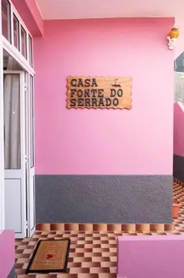 a pink wall with a sign on a house at Casa Fonte do Serrado in Caniçal