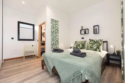 a bedroom with a bed with a green blanket at The View Flat by Rent-a-key in Funchal