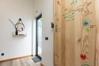 a room with a wooden door with writing on the wall at The View Flat by Rent-a-key in Funchal