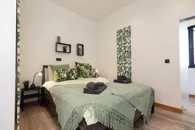 a bedroom with a bed with a green blanket at The View Flat by Rent-a-key in Funchal