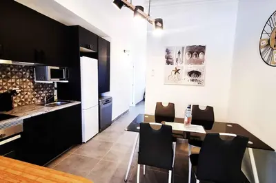 a kitchen and dining room with a table and chairs at Sun & Fun in Sagres in Sagres