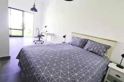 a bedroom with a bed with a purple comforter at Sun & Fun in Sagres in Sagres