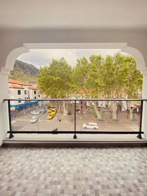 a large balcony with a view of a parking lot at Village Square Coastal Apartment 3G in Machico