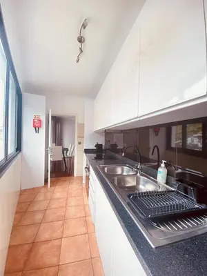 a kitchen with a sink and a counter top at Village Square Coastal Apartment 3G in Machico