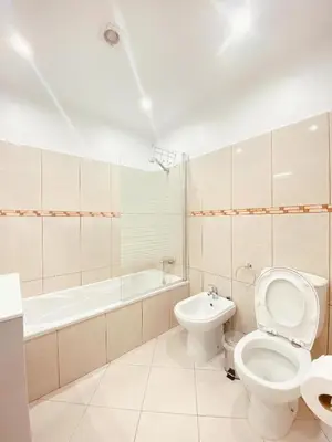 a bathroom with a toilet and a bath tub at Village Square Coastal Apartment 3G in Machico