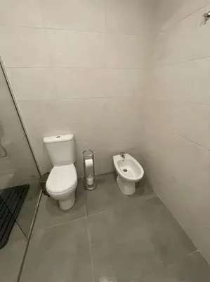 a white bathroom with a toilet and a bidet at Villa Do Calo in Sagres