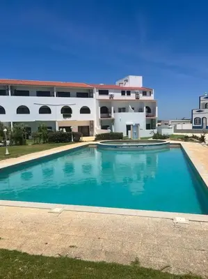 a large blue swimming pool in front of a building at Villa Do Calo in Sagres