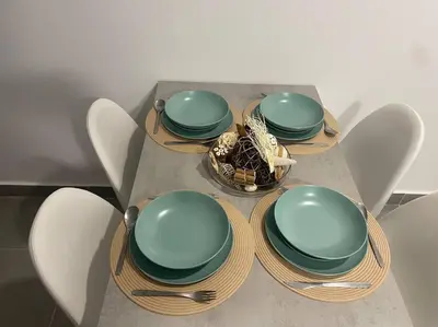 a table with four plates and a bowl of food at Villa Do Calo in Sagres