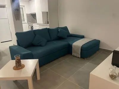 a blue couch in a living room with a table at Villa Do Calo in Sagres