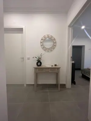 a room with a table and a mirror on the wall at Villa Do Calo in Sagres