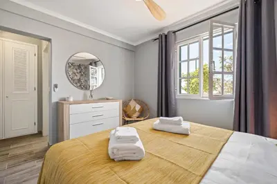 a bedroom with a large bed with two towels on it at Villa Pedreiro in Funchal