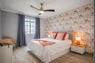 a bedroom with a bed and a ceiling fan at Villa Pedreiro in Funchal