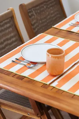 a table with a plate and a cup on it at Casa Primeira in Vila do Bispo