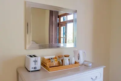 a mirror on top of a dresser in a room at São Vicente Guest House in São Vicente