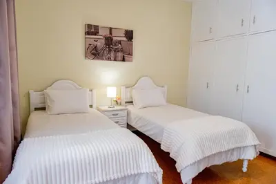 two beds sitting next to each other in a room at São Vicente Guest House in São Vicente
