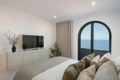 a bedroom with a large bed and a television at Lazareto Sea View by An Island Apart in Funchal