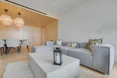 a living room with a couch and a table at Chic Two-Bedroom En Suite in Central Town - Savoy Residence in Funchal