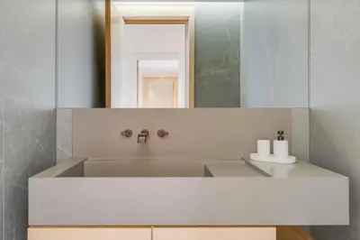 a bathroom with a sink and a mirror at Chic Two-Bedroom En Suite in Central Town - Savoy Residence in Funchal