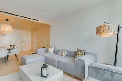 a living room with a couch and a table at Chic Two-Bedroom En Suite in Central Town - Savoy Residence in Funchal
