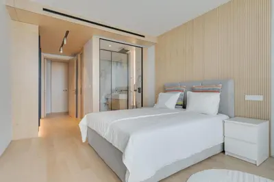 a bedroom with a large white bed in it at Chic Two-Bedroom En Suite in Central Town - Savoy Residence in Funchal