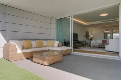 a living room with a couch and a table at Luxurious Ocean and Sunset Views Family Haven with 3 En-Suite Bedrooms and Pool in Funchal