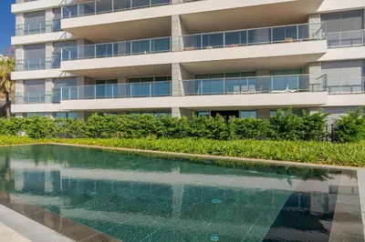 an apartment building with a swimming pool in front of it at Luxurious Ocean and Sunset Views Family Haven with 3 En-Suite Bedrooms and Pool in Funchal