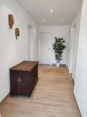 a hallway with a table and a potted plant at MONTE s PEDRO in Lagos