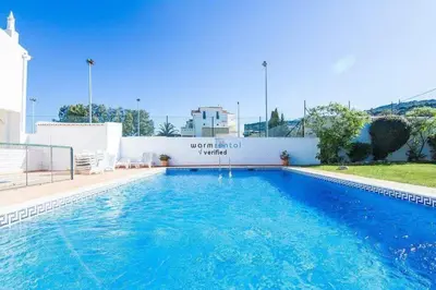 a large blue swimming pool in front of a building at APARTAMENTOS OASIS BEACh in Lagos