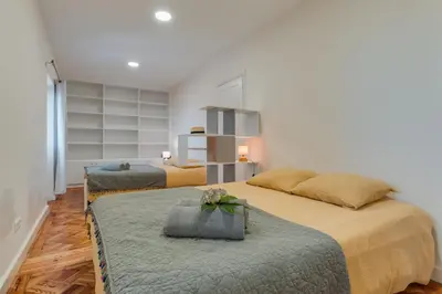 two beds in a room with white walls at Villa Natural Oasis with panoramic view & bio-diverse 9 950m2 garden in Funchal