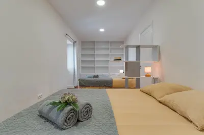 a bedroom with two beds and a large bed at Villa Natural Oasis with panoramic view & bio-diverse 9 950m2 garden in Funchal