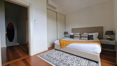 a bedroom with a large bed and a rug at The Red Hot Chill House by LovelyStay in Arco da Calheta