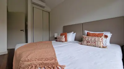 a bedroom with a large white bed with pillows at The Red Hot Chill House by LovelyStay in Arco da Calheta