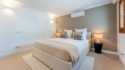 a bedroom with a large white bed with two pillows at Villa Maya Luxurious House With Pool by LovelyStay in Luz