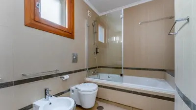 a bathroom with a toilet and a tub and a sink at Villa Maya Luxurious House With Pool by LovelyStay in Luz