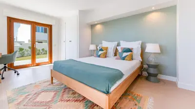 a bedroom with a large bed and a window at Villa Maya Luxurious House With Pool by LovelyStay in Luz