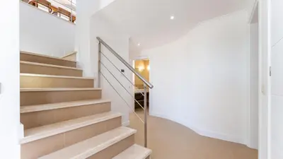 a staircase in a home with white walls and white floors at Villa Maya Luxurious House With Pool by LovelyStay in Luz