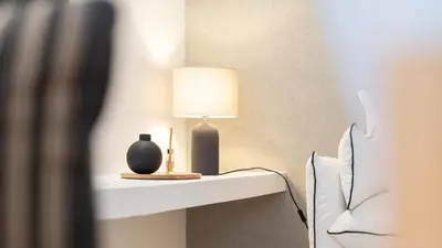 a lamp on a shelf next to a bed at Villa Maya Luxurious House With Pool by LovelyStay in Luz
