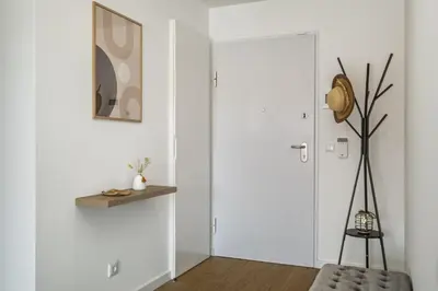 a room with white walls and a door with a shelf at Penthouse A Fabrica by Homie in Funchal