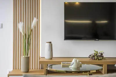 a living room with a tv and a glass table at Penthouse A Fabrica by Homie in Funchal
