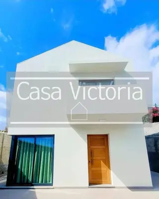 a white building with a door in front of it at Casa Victória in Funchal