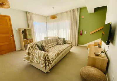 a living room with a couch and a table at Casa Victória in Funchal