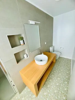 a bathroom with a sink and a mirror and a toilet at Casa Victória in Funchal