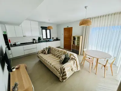 a living room with a couch and a table at Casa Victória in Funchal